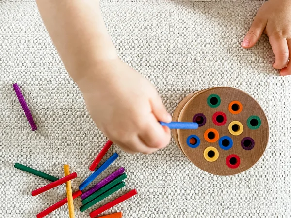 Child playing with colourful toys